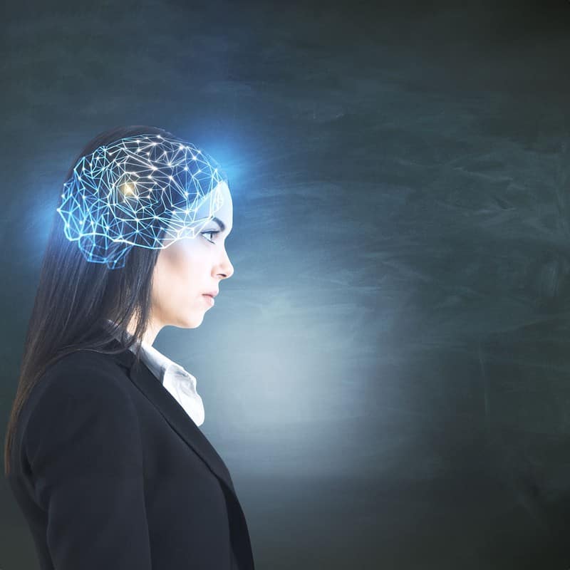 Businesswoman with glowing polygonal brain on blackboard background. Artificial intelligence and data concept. Multiexposure