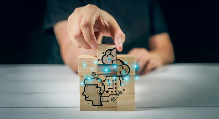 A person is holding a neurotech project involving a wooden block with a drawing on it.