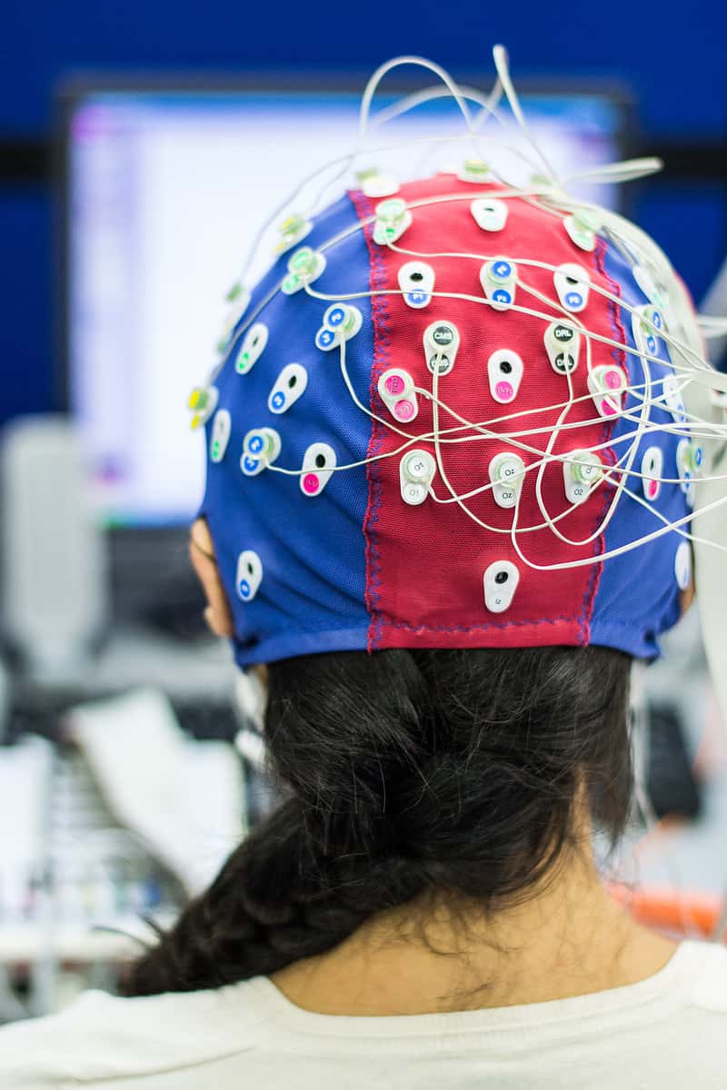 A woman's head is covered with wires in this intriguing image.